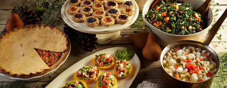 a table topped with lots of food and pies on top of plates next to each other