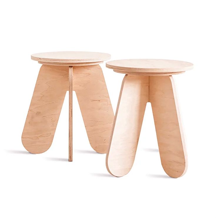 two wooden stools sitting next to each other