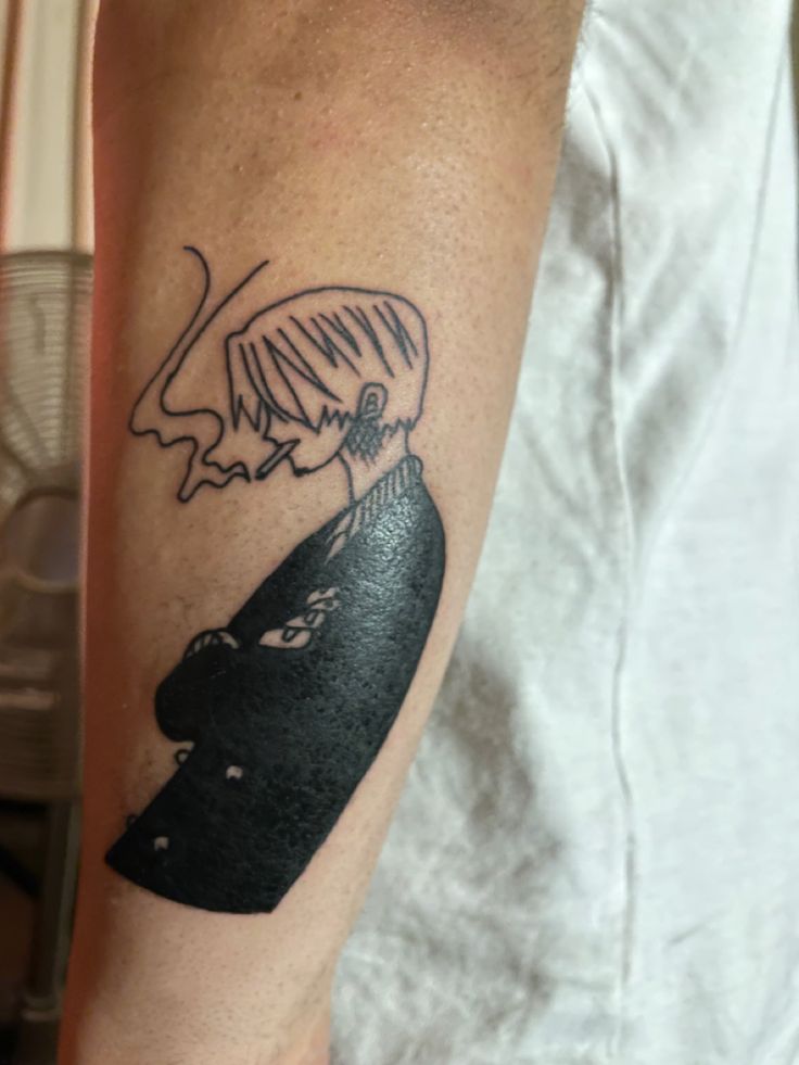 a man with a tattoo on his arm has a black and white drawing of a woman's head