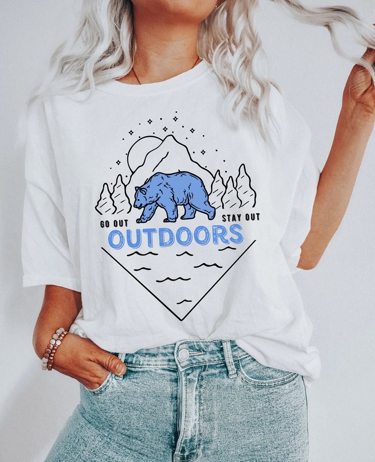 The Great Outdoors graphic tee with illustration of a wild bear in the woods surrounded by nature with the message "Go out and stay out". Great apparel gift for campers, hikers, travelers, wanderlust, outdoors and nature lovers. ** ABOUT PRODUCT** This classic unisex jersey short sleeve tee fits like a well-loved favorite. Soft cotton and quality print make users fall in love with it over and over again. These t-shirts have ribbed knit collars to bolster shaping. The shoulders have taping for be Tropical Svg, Vsco Shirts, Library Shirt, Book Nerd Shirts, Nerd Shirt, Boho Tropical, Cowgirl Gifts, Space Shirts, Western Graphic Tees