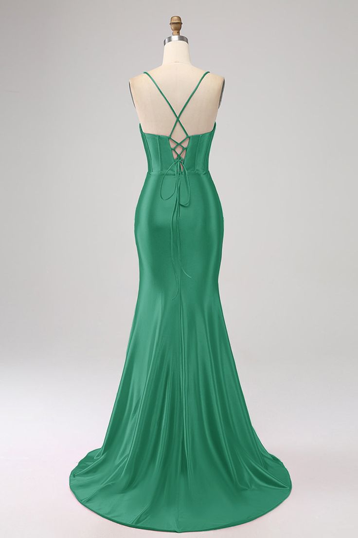 the back of a green evening gown on a mannequin