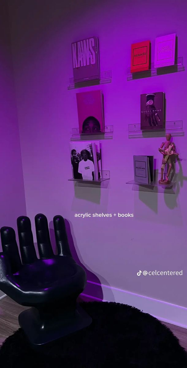 a room with purple lighting and shelves on the wall that have various items on them