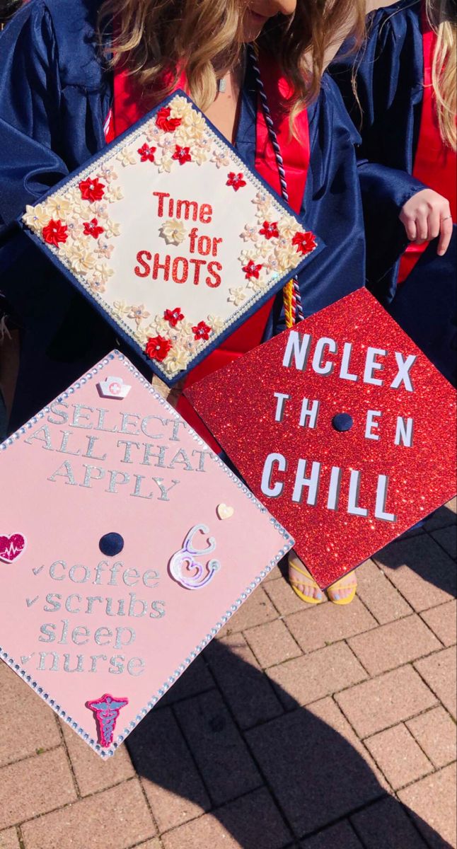 two graduates in caps and gowns hold up their graduation hats that read time for shots, nclex then chill