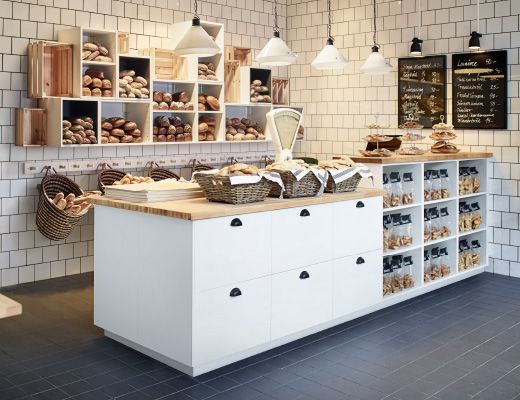 a bakery filled with lots of different types of breads and pastries on display