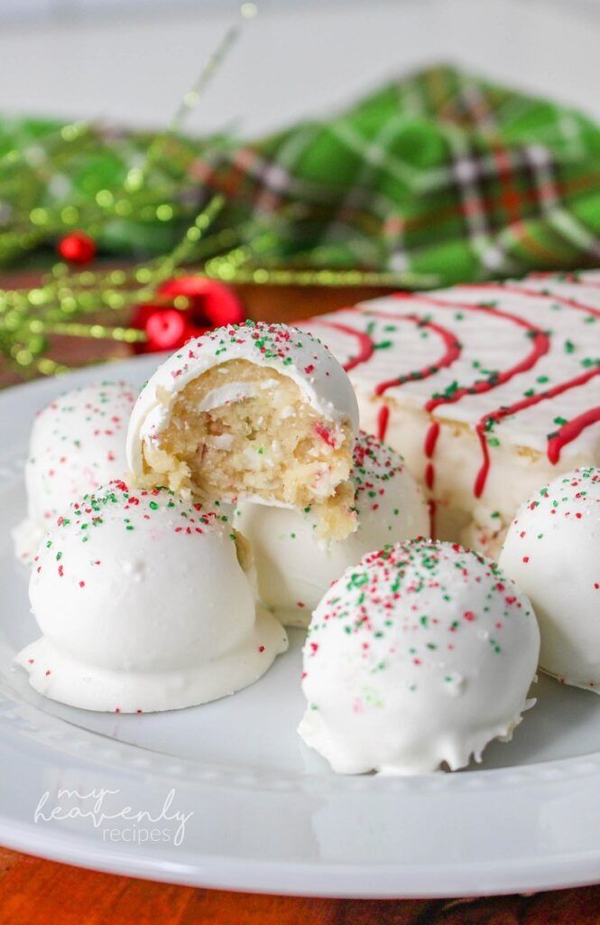 a plate with some white cake and candy canes on it, next to a green christmas tree