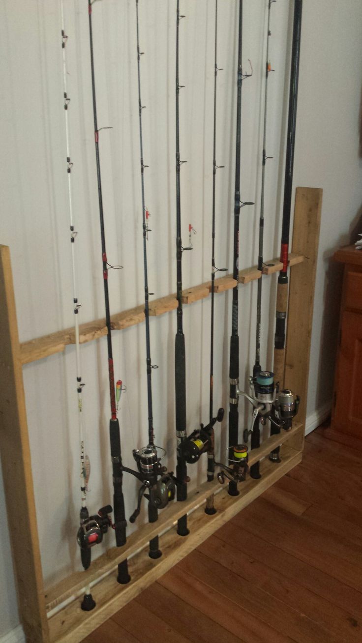 the fishing rods are lined up against the wall