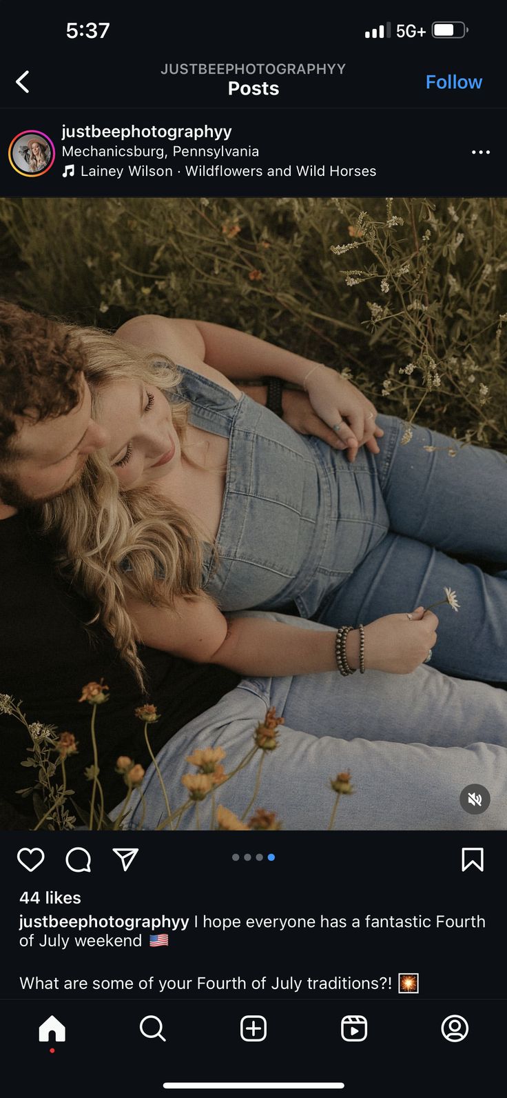 a woman is laying down in the grass with her hands on her hips and looking at the camera