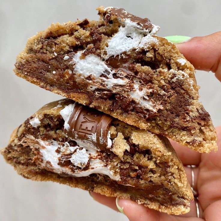 two pieces of chocolate chip cookie with marshmallows