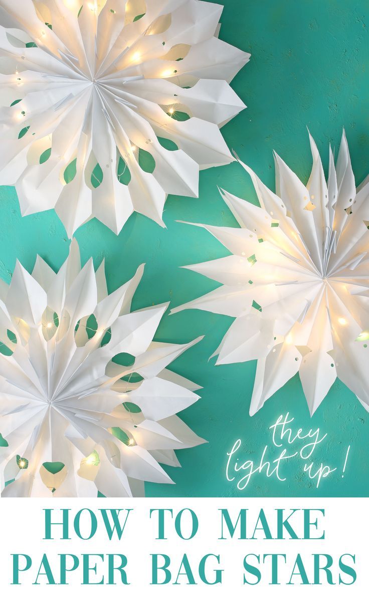 white paper flowers with text overlay how to make paper bag stars that look like snowflakes