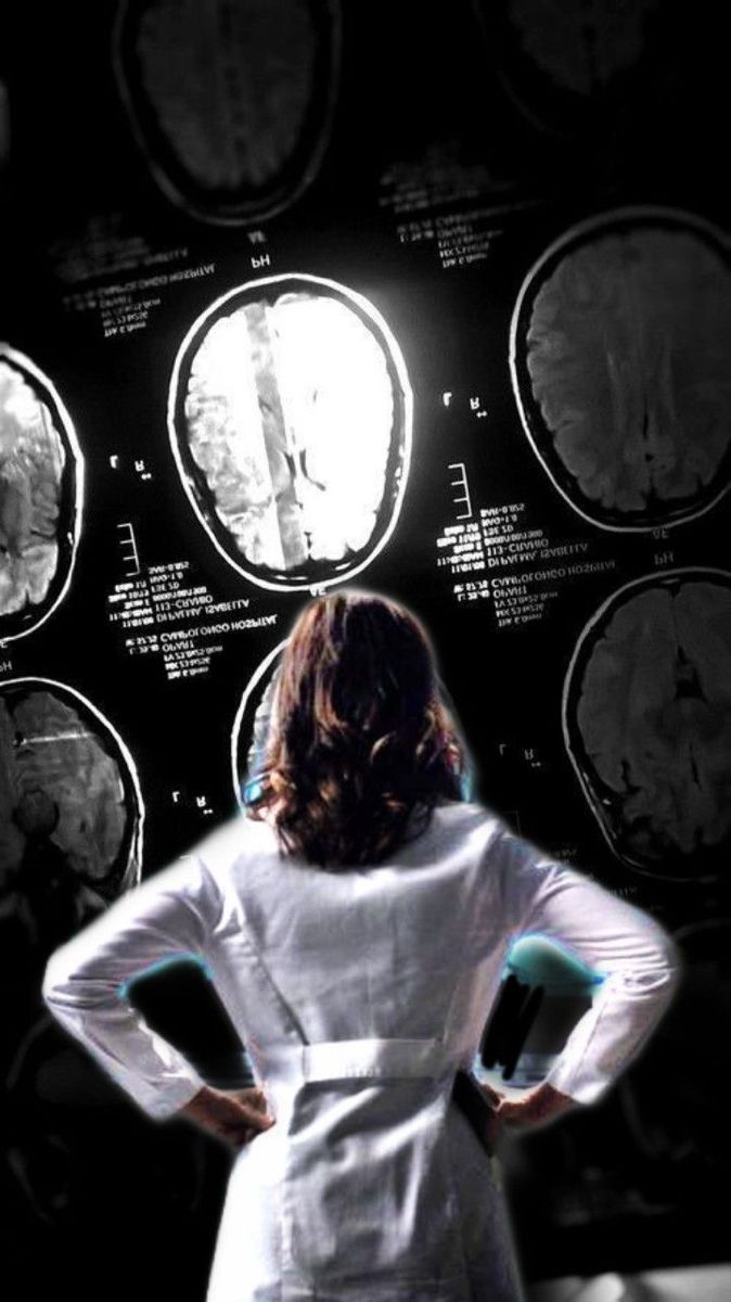 a woman standing in front of mri images