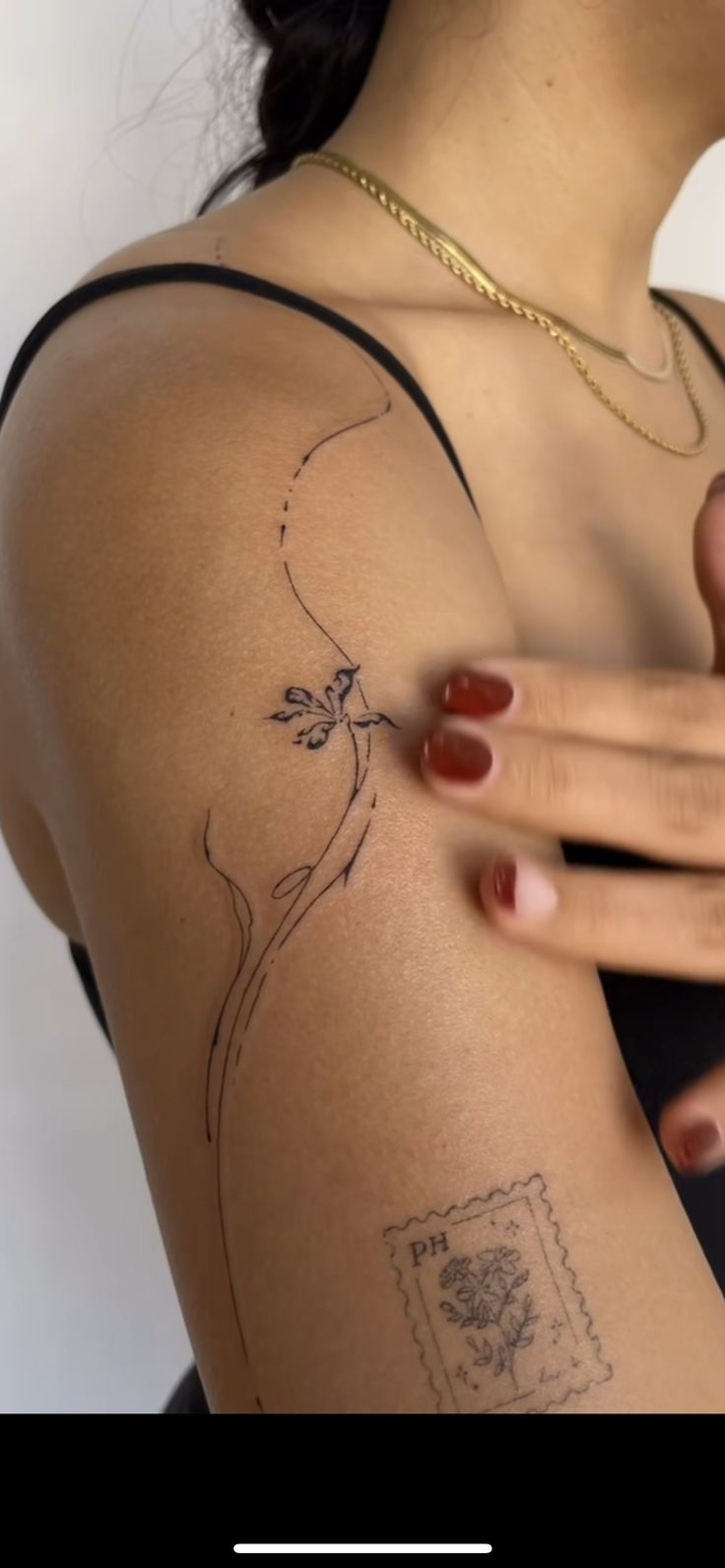 a woman's arm with a tattoo on the back of her shoulder and hand