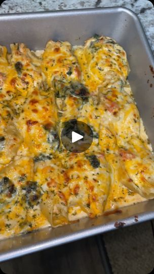 a casserole dish with cheese and spinach on it in a metal pan