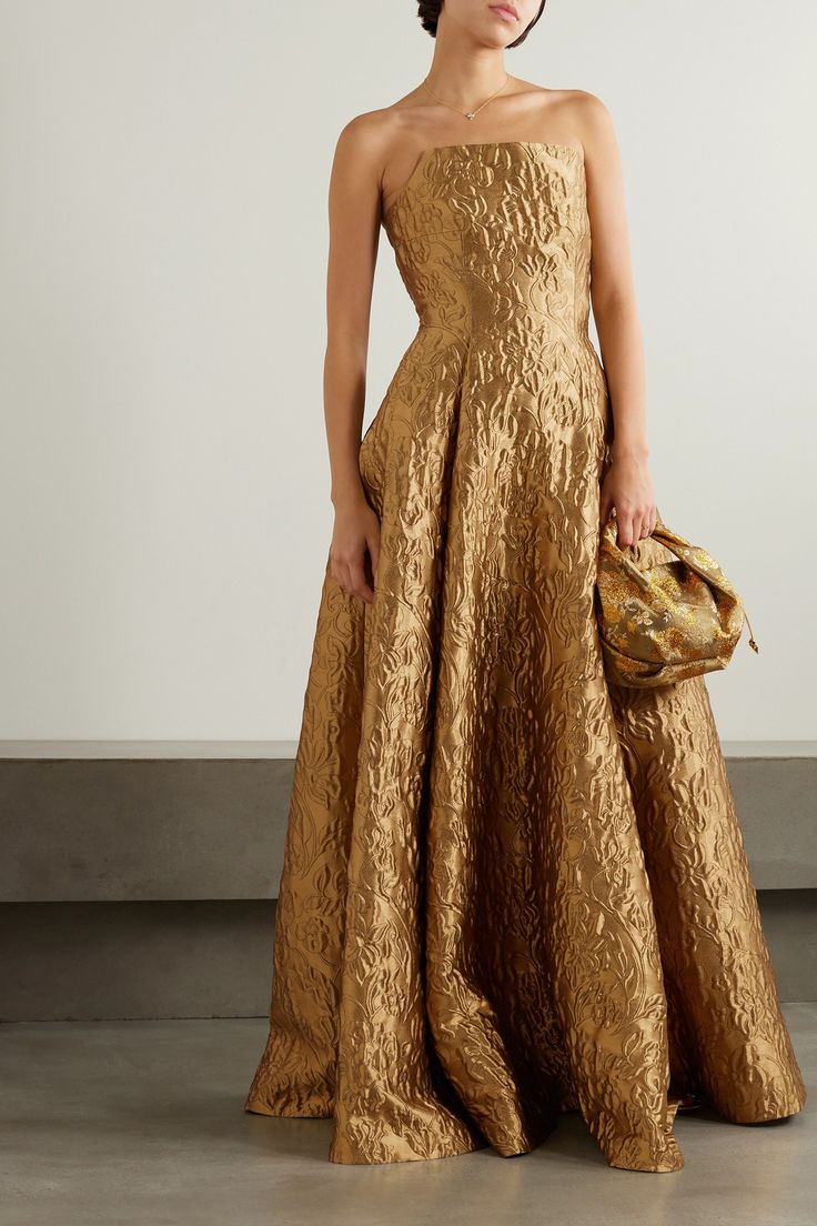 Emilia Wickstead's 'Alivia' gown portrays the timeless elegance of Golden Age glamour. Crafted from gold brocade enriched with opulent floral embroidery, it has a sculptural bodice with internal boning and voluminous skirt that's pleated to hold the beautiful structure. Opt for dewy makeup for a truly radiant look. Gold Gowns Elegant, Cocktail Dress Attire, Gold Ball Gowns, Jacquard Dresses, Gold Brocade Dress, Brocade Gown, Fall Wedding Bridesmaids, Gown Gold, Holiday Party Attire