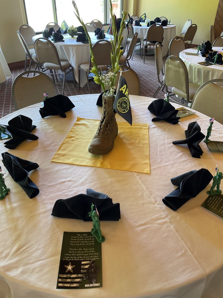 the table is set up with decorations and place settings for people to sit at it