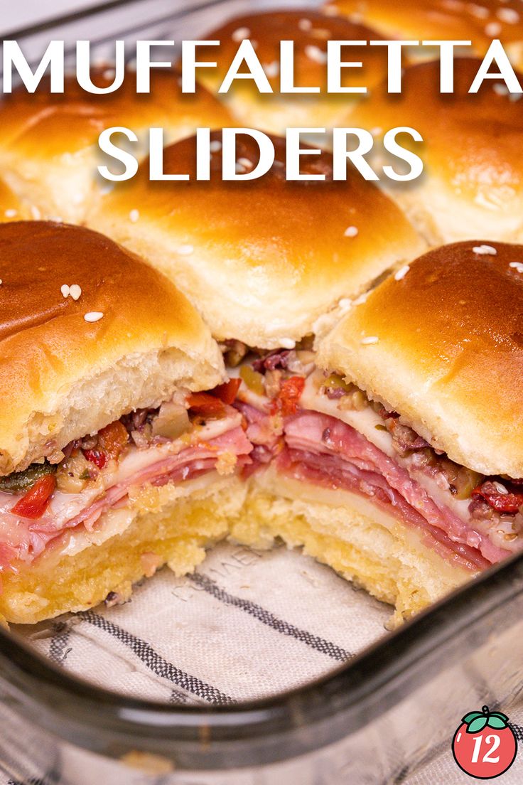 a close up of a sandwich in a pan with the words muffaletta sliders