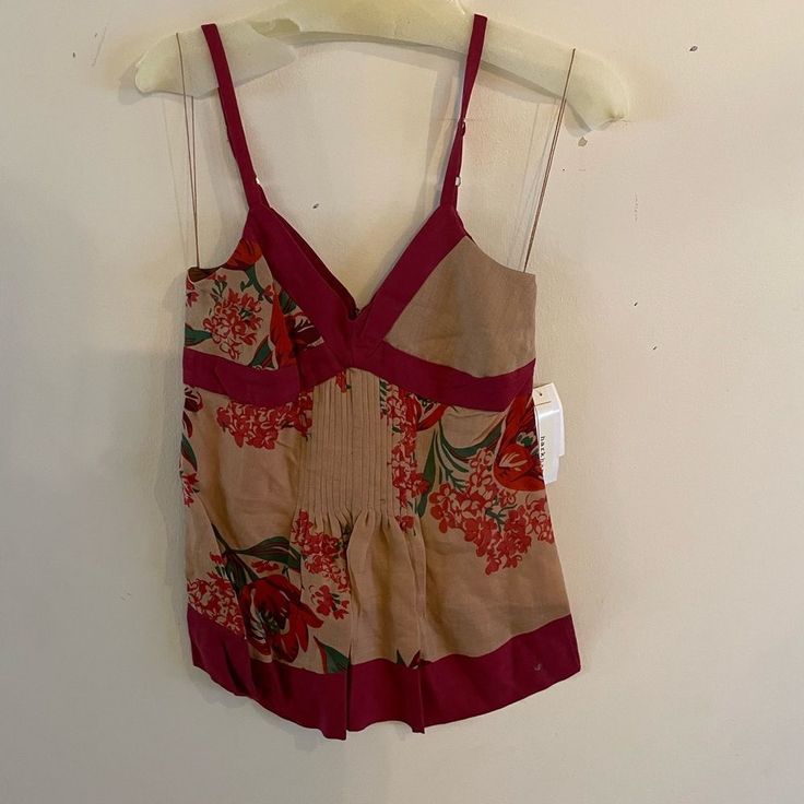 Material: 50% Silk, 50% Wool; Lining: 100% Silk Fit: Fitted Length: 26.5 Inches Details: Pretty Top Features Empire Waist, Pintuck Detailing At Front, Pleats Throughout, Beautiful Red Floral Design, Burgundy Contrasting Trim, Zipper In Back, Adjustable Bra Straps And Lined At Bodice. Sleeveless Care: Dry Clean Only Origin: Made In The China Sleeveless Silk Top With Floral Print, Casual Silk Top With Floral Print, Casual Silk Tops With Floral Print, Spring Silk Tops With Floral Print, Silk Floral Print Beach Top, Silk Floral Print Top For Beach, Silk Floral Print Tops, Fitted Silk Top For Vacation, White Cami Tops