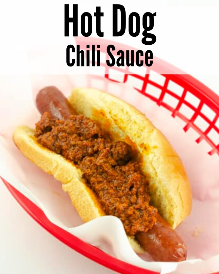 a chili dog in a red basket with the words hot dog chili sauce