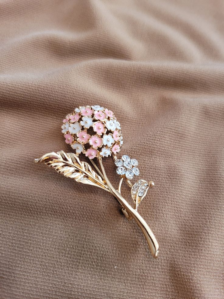 The brooch has a single pink and white enameled lilac flower with leaves and a smaller full crystal accented flower.  Gold plated. Elegant Flower Shaped Enamel Pin For Formal Occasions, Elegant Flower Enamel Pin, Elegant Formal Flower Enamel Pin, Elegant Formal Flower Shaped Enamel Pin, Wedding Enamel Pin Brooch, Elegant Pink Flower Pins, Elegant Pink Enamel Brooch Pin, Flower Shaped Enamel Pin For Gift, Elegant Pink Enamel Pin