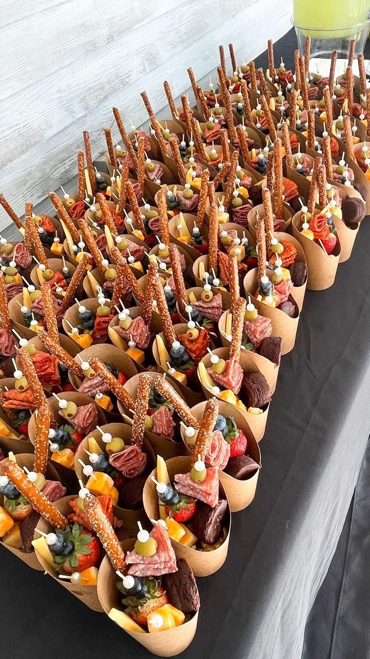 a table topped with cups filled with different types of snacks and desserts next to each other