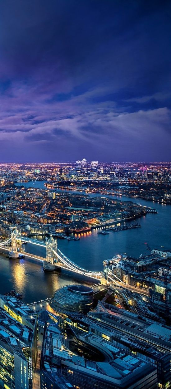 an aerial view of london at night with the shard tower in the foreground