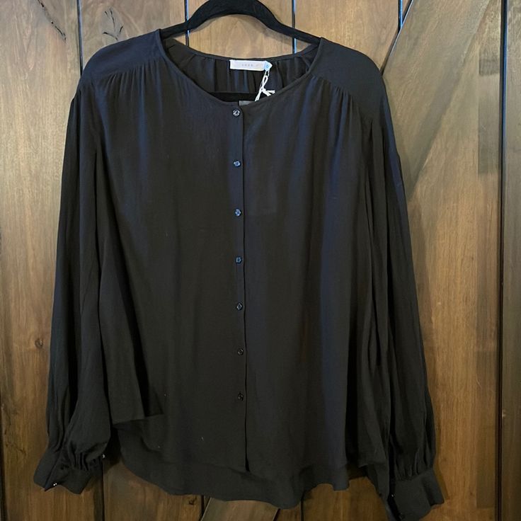 This Is A Beautiful Blouse By Lush In A Size Large, With Button Cuffs, And Button Front, It Is Higher In The Front And Longer In The Back, And Is Absolutely Beautiful. Send Me Any Questions You Have And Thank You For Looking! Black Tops With Covered Buttons For Fall, Chic Black Blouse With Button Cuffs, Black Blouse With Button Cuffs For Daywear, Black Button-up Tops With Covered Buttons, Black Blouse With Button Closure For Daywear, Black Button-up Blouse With Back Button Closure, Black Button-up Blouse For Daywear, Black Button-up Blouse With Button Closure, Tan Blouse