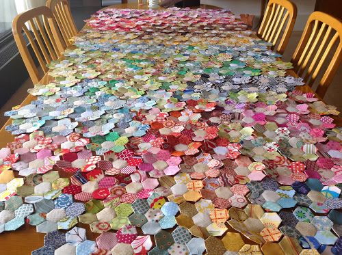 the table is covered with many different colored plates