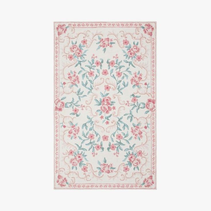 a white rug with pink and blue flowers on the bottom, in front of a white background