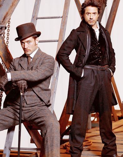 two men in top hats and tails standing next to each other with their hands on their hips