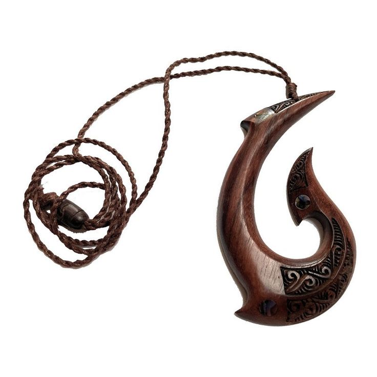 a wooden necklace with an animal's head hanging from the end, on a cord