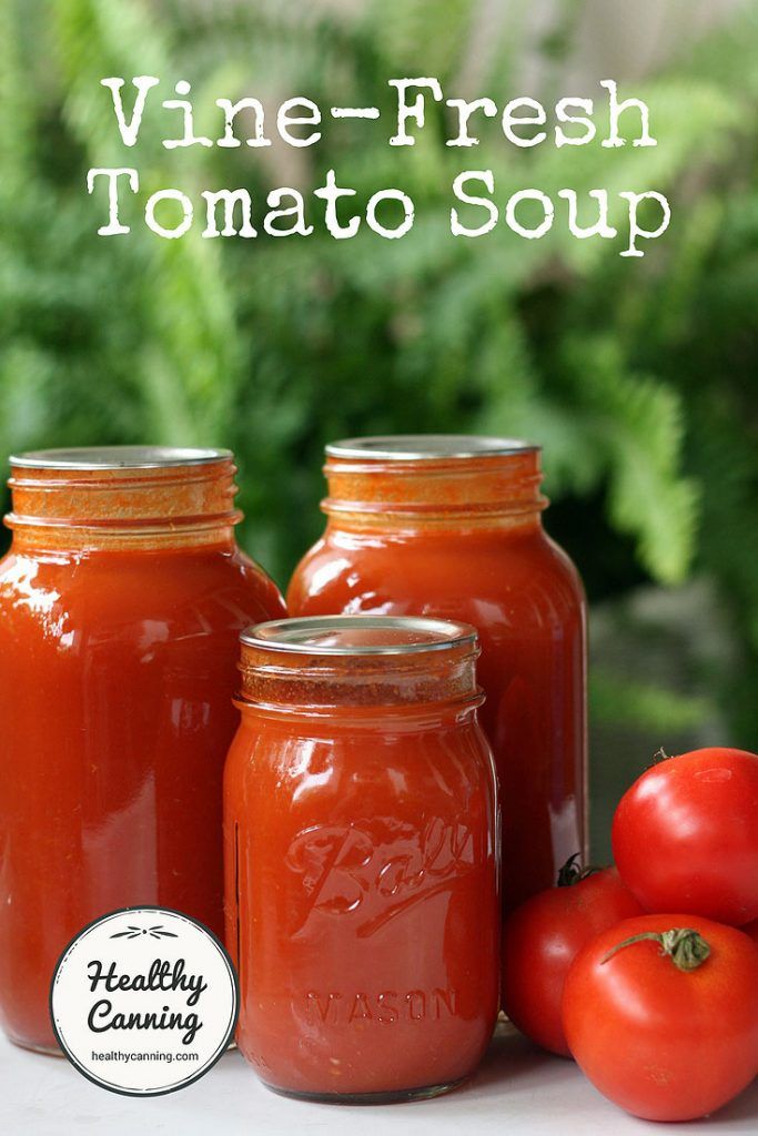 three jars filled with tomatoes sitting next to each other