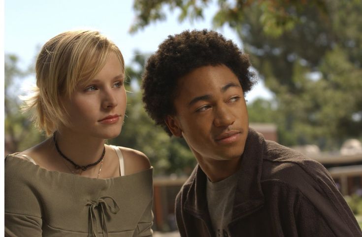 a young man and woman sitting next to each other