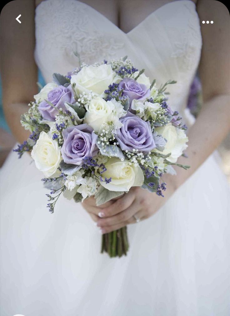 a bride holding a bouquet of white and purple flowers on her wedding day with the caption pin it