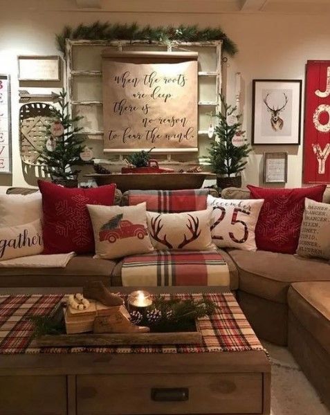 a living room filled with lots of furniture and christmas decorations on top of the couches