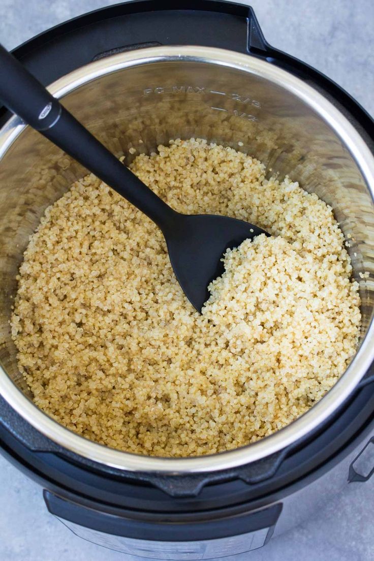 rice is being cooked in an instant pot with a black spatula on the side