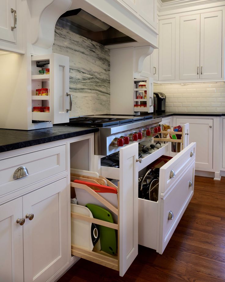 an open drawer in the middle of a kitchen