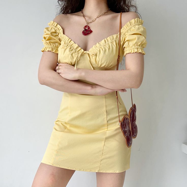 A romantic French style dress with a bustier design and playful puff sleeves. Centre-piece tie with a flattering high-waist cinch silhouette. Available in Goose Yellow. White & Black. Details: 97% Cotton / 3% Spandex Cold Hand Wash / Cool Iron Handmade pieces will take 2-4 weeks to dispatch Size / Fit: Length is measured from centre back Runs small Model wears a Small Model Info: Chest 82 cm Waist 65 cm Hips 88 cm Height 165 cm SIZE CHART Bust Waist Length Small 70 cm 62 cm 78 cm Medium 74 cm 66 Trendy Puff Sleeve Dress With Ruffles, Flirty Ruched Corset Dress With Square Neck, Trendy Fitted Puff Sleeve Dress With Ruffles, Flirty Square Neck Corset Dress With Ruched Detail, Flirty Square Neck Ruched Corset Dress, Flirty Ruched Corset Dress For Spring, Fitted Off-shoulder Puff Sleeve Dress For Day Out, Summer Mini Dress With Gathered Sleeves And Sweetheart Neckline, Spring Off-shoulder Puff Sleeve Dress For Date Night