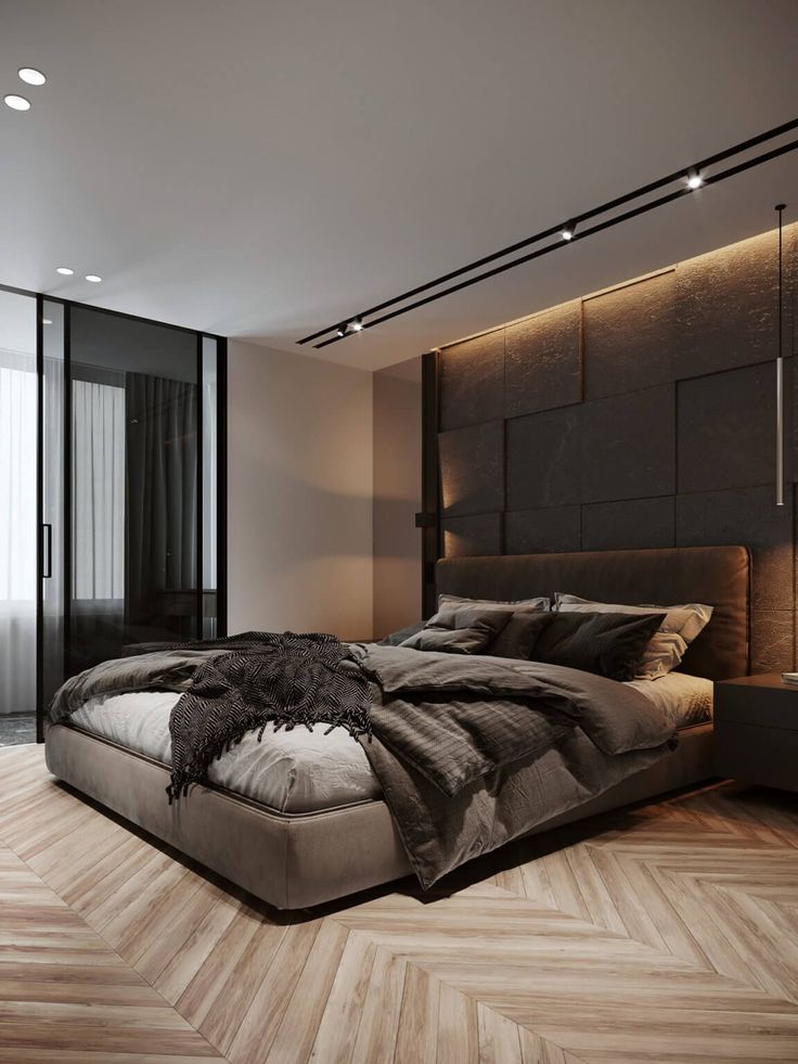 a large bed sitting in the middle of a bedroom next to a wall mounted tv