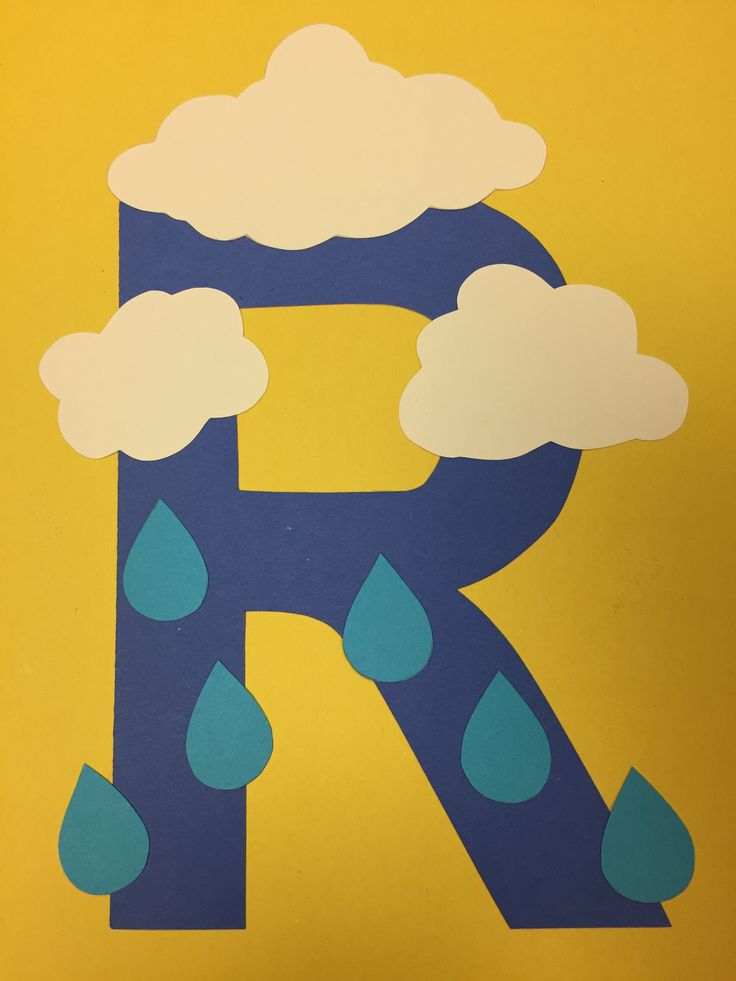 the letter r is made out of paper and has rain drops on it, as well as clouds