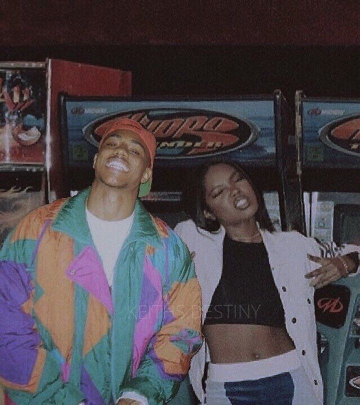 two people standing next to each other in front of slot machines