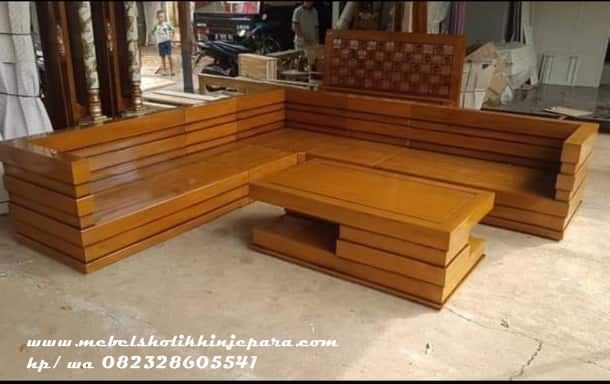 a wooden bench sitting on top of a cement floor