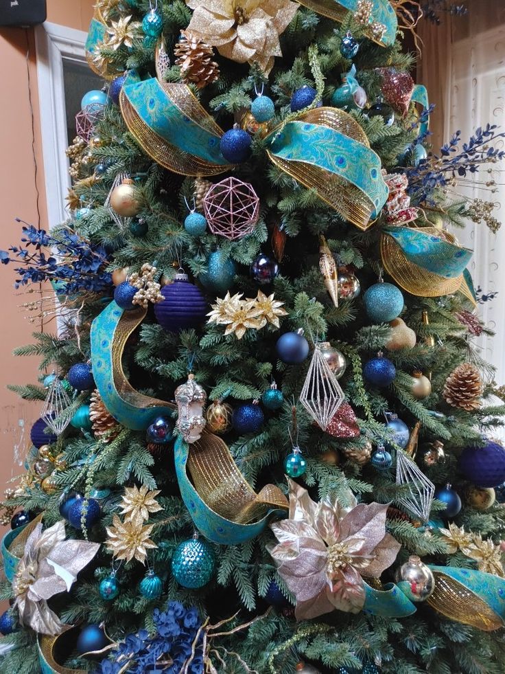 a decorated christmas tree with blue and gold ornaments