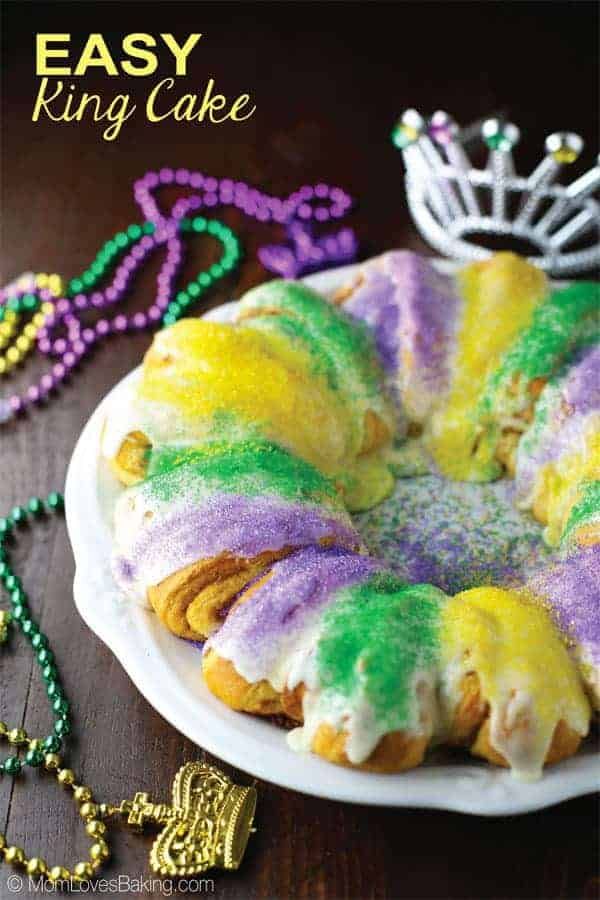 a cake that is sitting on a plate with beads and a crown in the background