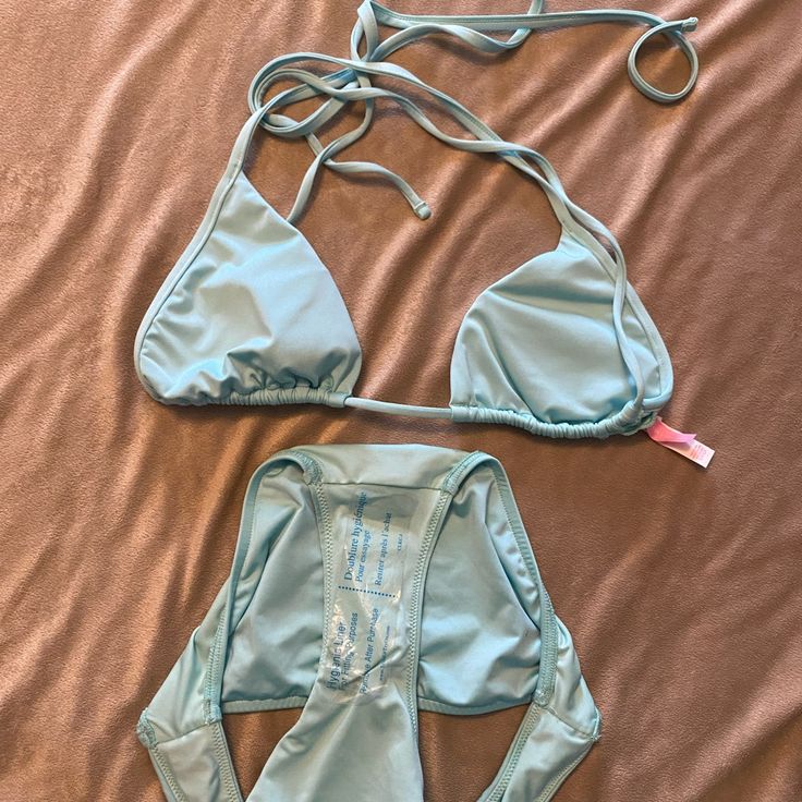 Victoria’s Secret Bikini. Size Small Top, Medium Bottoms. Never Worn. Blue T-back Halter Top For Poolside, Light Blue Fitted Halter Neck Swimwear, Blue Backless Halter Top For Beachwear, Blue Backless Halter Top For Poolside, Blue Backless Halter Top For Beach Season, Beach Season Party Halter Top With Tie-side Bottom, Fitted Blue Halter Top For Beach Party, Light Blue Stretch Swimwear For Party, Light Blue Halter Neck Swimwear For Poolside