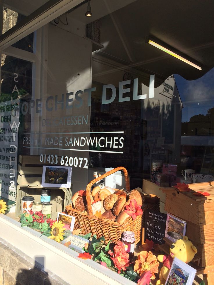 a display in the window of a deli filled with bread and pastries