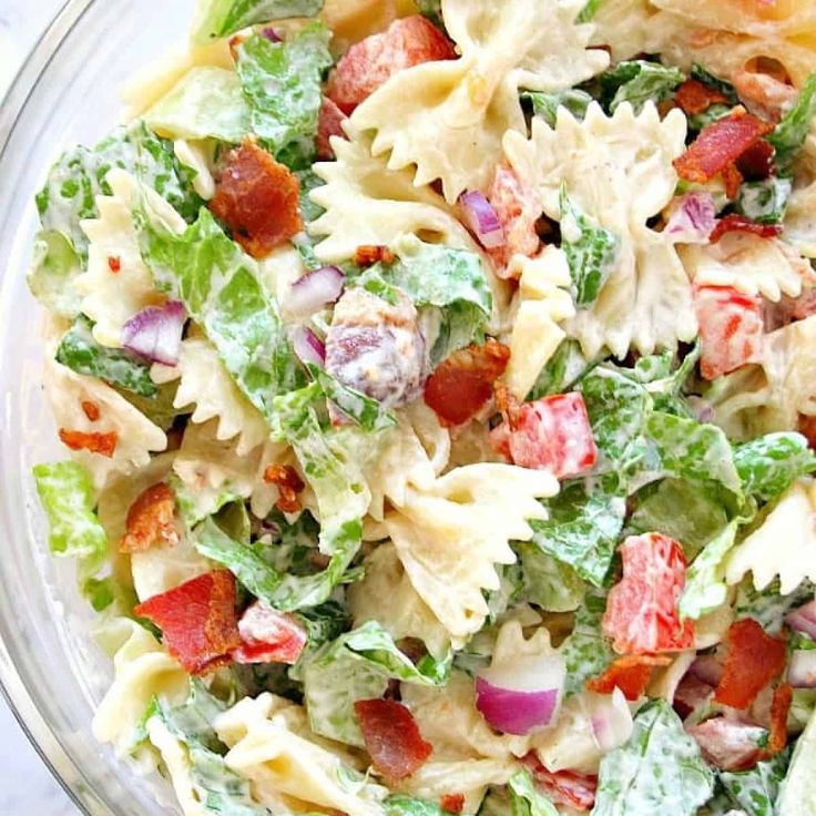 a bowl filled with pasta salad on top of a table