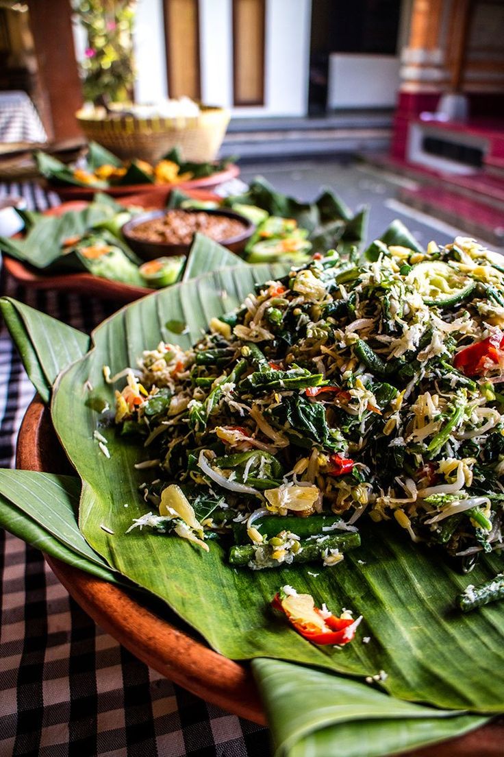 there are many plates on the table with different food items in each plate, including rice and vegetables