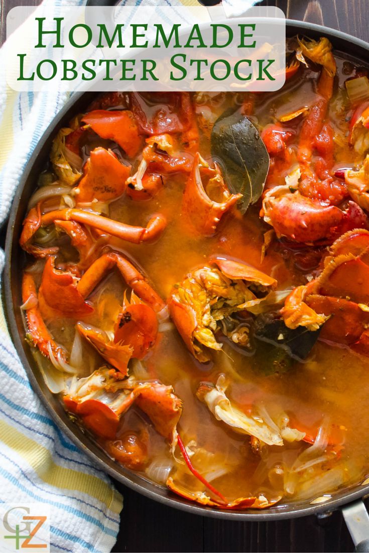 a pot filled with lobster stew on top of a wooden table