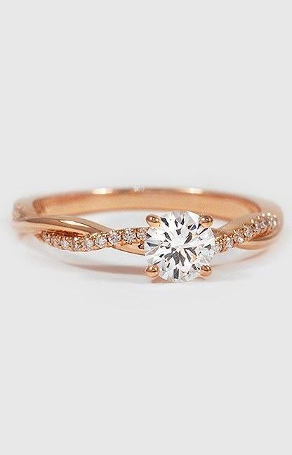 a rose gold engagement ring with a round diamond in the center