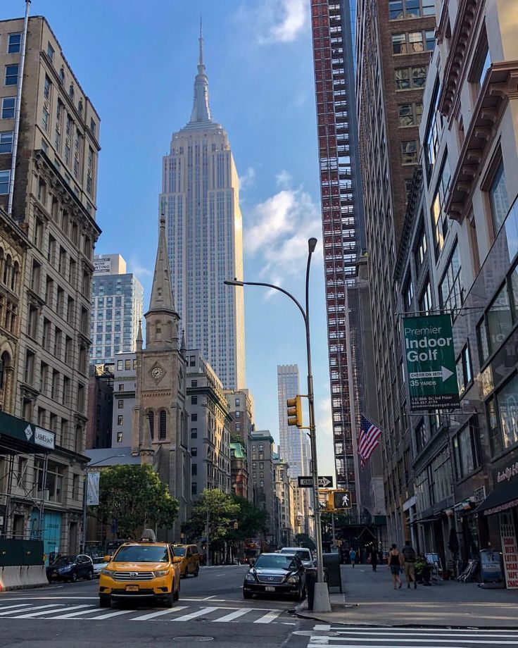 a city street with tall buildings in the background