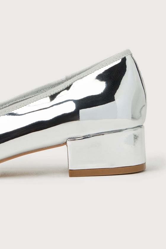 Making your look even more remarkable is easy with the Steve Madden Cherish Silver Patent Bow Low Heel Pumps! Shiny faux patent leather shapes these mesmerizing heels that feature a round toe, adorned with a dainty bow detail. A low block heel completes the trendy ballet pump design! 1. 5" block heel. Lightly cushioned insole. Rubber sole has nonskid markings. Man made materials. Imported. Lulus | Cherish Silver Patent Bow Low Heel Pumps | Size 7.5. Spring Metallic Low Heel Shoes, Party Patent Leather Block Heels Medium Width, Modern Low Heel Block Heels For Party, Chic Shiny Patent Leather Heels, Party Patent Leather Block Heels With Reinforced Heel, Chic Round Toe Heels With Glossy Finish, Sleek Silver Patent Leather Heels, Spring Patent Leather Block Heels For Party, Modern Metallic Block Heel Shoes